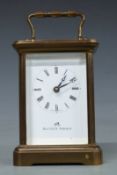 A 20thC brass carriage clock by Matthew Norman in corniche style case, the Roman enamel dial with