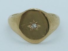 A 9ct gold signet ring set with a diamond in a star setting, 6.5g, size T