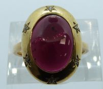 An 18ct gold ring set with a garnet cabochon and diamonds, 7.9g, size M