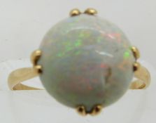 A yellow metal ring set with a round opal cabochon, 2g, size H