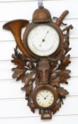 Late 19thC/early 20thC Black Forest barometer, thermometer, clock compendium with carved hunting/