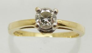 An 18ct gold ring set with a round brilliant cut diamond of approximately 0.4ct with further