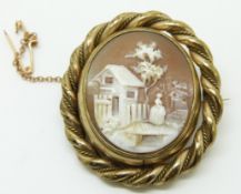Victorian pinchbeck swivel brooch set with a cameo depicting a woman, house and a bridge, 3.5 x 4cm