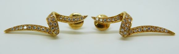 A pair of yellow metal earrings set with diamonds in a twist design, 5.7g