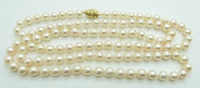 A single strand cultured pearl necklace with 14k gold clasp set with a diamond