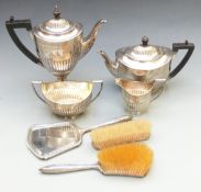 Three piece hallmarked silver dressing table set comprising hand mirror and two brushes together
