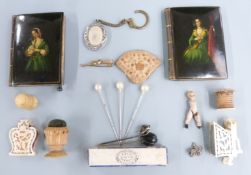 A pair of 19thC continental lacquer notebooks, pin cushions, Victorian knot stick pin, early piece