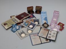 A large collection of approximately 40 modern crowns, £2 and £1 coins etc, mostly cased or in
