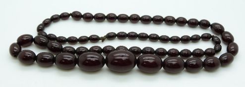 A graduated cherry amber necklace made up of 63 oval beads, 73g