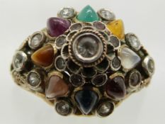 A yellow metal ring set with garnets, tiger's eye, ruby, citrine, emerald, sapphire etc, 4.6g,