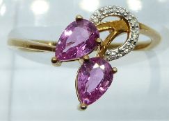 A 9ct gold ring set with diamonds and pear cut pink sapphires, 1.8g, size N
