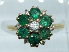 A yellow metal ring set with emeralds, diamonds and paste in a cluster, 4g, size K