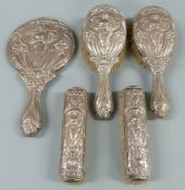 Art Nouveau hallmarked silver dressing table set comprising hand mirror and four brushes, Birmingham