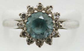 An 18ct white gold ring set with a round cut zircon and surrounded by diamonds, 3.9g, size J/K
