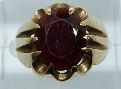 A 9ct gold ring set with a large garnet, 6g, size L