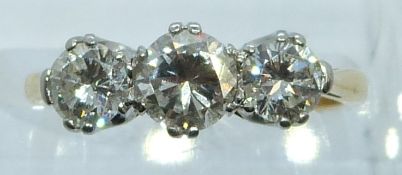 An 18ct gold ring set with three round cut diamonds of approximately 0.5ct, 0.2ct and 0.2ct in a