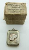A silver locket depicting a dog and crop, verso engraved decoration, Chester 1911