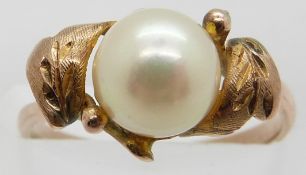 A yellow metal ring set with a pearl in a foliate design, 2.1g, size J