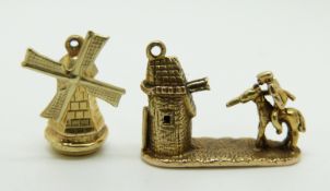 A yellow metal windmill charm and a 9ct gold charm depicting a knight and castle, 6.3g