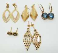 A pair of 9ct tri-coloured gold earrings, a pair of yellow metal earrings set with a diamond and