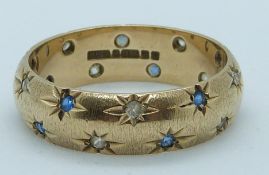 A 9ct gold ring set with paste in star settings, 4.7g, size Q