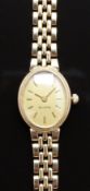 9ct gold ladies wristwatch with gold hands, baton markers and dial, on 9ct gold bracelet, case