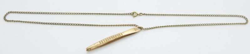 A 9ct gold pendant in the form of tweezers set with a diamond, 3g