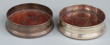 Pair of hallmarked silver wine coasters with mahogany bases, Birmingham 1982 maker K M Silver,