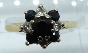 An 18ct gold ring set with round cut sapphires and diamonds, 3.4g, size L