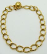 A yellow metal bracelet with globe charm impressed with indistinct hallmarks, likely 22ct, 7.2g