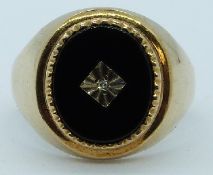 A 9ct gold ring set with onyx and diamond, 6.8g, size V/W