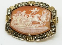 A silver gilt brooch set with a cameo depicting a chariot and cherubs, with marcasite to the border,