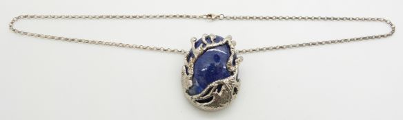 A large sapphire cabochon (150ct) set into a bespoke silver pendant setting, on silver chain