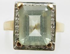 A 9ct gold ring set with an aquamarine and diamonds, 3.4g, size M