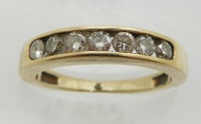 A 9ct gold ring set with seven round cut diamonds, 2.6g, size L