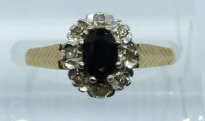 A 9ct gold ring set with a sapphire and diamonds, 2g, size M