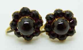 A pair of Victorian yellow metal earrings set with a cluster of garnets to each