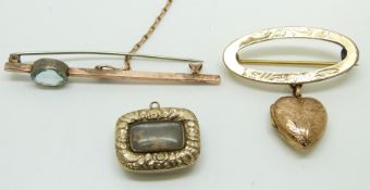 A 9ct gold brooch set with an oval cut aquamarine, a Victorian brooch with a glass compartment to