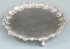 Georgian hallmarked silver salver with scrolling edge and engraved decoration, raised on three