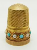 A yellow metal thimble set with pearls and turquoise in original box