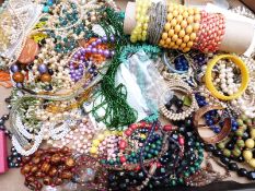 A collection of costume jewellery including coral necklace, glass beads, silver bangle, Art Deco