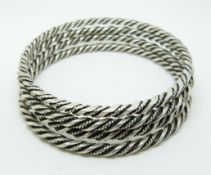 Four Georg Jensen silver bangles with rope twist decoration