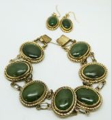 A silver gilt bracelet set with nephrite jade cabochons and matching earrings