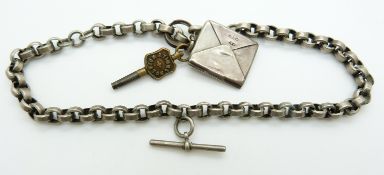 A white metal Albert/ fob chain made up of oval links together with a silver stamp holder in the