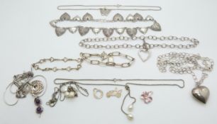 A collection of silver necklaces including one made up of heart links, pearl, amethyst, Thomas