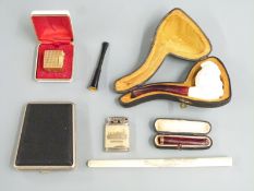 Cased Meerschaum pipe with carved bust decoration, cased cherry amber and 9ct gold cheroot holder,