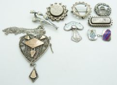 A silver filigree pendant, three Victorian white metal brooches, blister pearl brooch and Charles
