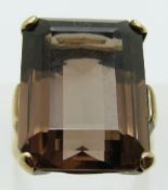 A 9ct gold ring set with an emerald cut smoky quartz, 8.7g, size L