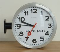 'Nextime' Jaguar two sided dial wall clock with side mounting brackets and bold Arabic numerals on