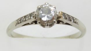 An 18ct white gold ring set with a diamond of approximately 0.35ct with diamond encrusted shoulders,